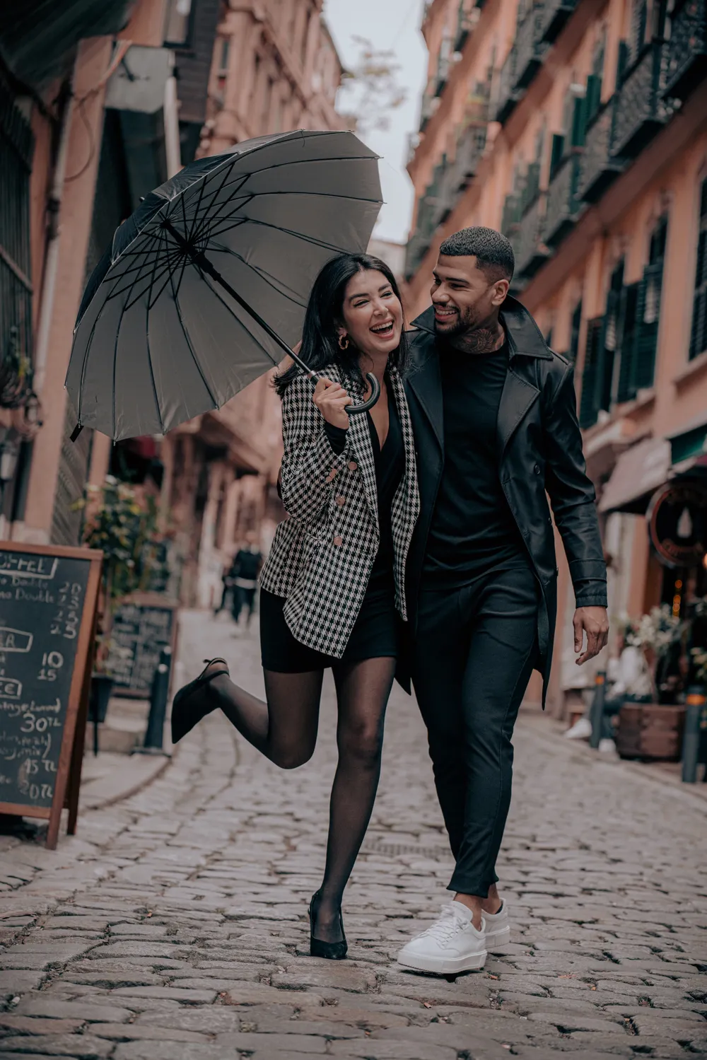 Couple laughing together on a city walk